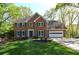 Charming two-story brick home with a well-manicured lawn and attached two car garage at 2815 Cambridge Hills Rd, Cumming, GA 30041