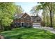 Traditional brick home with well-manicured lawn and attached two car garage at 2815 Cambridge Hills Rd, Cumming, GA 30041
