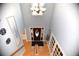 Bright, two-story foyer with hardwood floors, decorative chandelier, and front door at 2815 Cambridge Hills Rd, Cumming, GA 30041