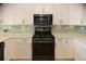Modern kitchen features white cabinets, stainless appliances, and stylish backsplash at 2815 Cambridge Hills Rd, Cumming, GA 30041