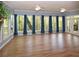 Well-lit room with hardwood floors and a large window view of the trees outside at 2815 Cambridge Hills Rd, Cumming, GA 30041