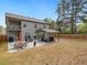 Spacious backyard featuring a covered patio with outdoor seating and a well-maintained lawn area at 3541 Stoneleigh Walk, Lithonia, GA 30038