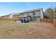 Expansive backyard features a covered patio, lawn, and privacy fence, perfect for outdoor enjoyment at 3541 Stoneleigh Walk, Lithonia, GA 30038