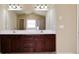 Bathroom featuring dual sinks, a vanity with storage, and a mirror at 3541 Stoneleigh Walk, Lithonia, GA 30038