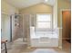 Bathroom featuring a separate shower and soaking tub at 3541 Stoneleigh Walk, Lithonia, GA 30038