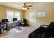 Functional bedroom with a ceiling fan, desk, computer, and futon at 3541 Stoneleigh Walk, Lithonia, GA 30038