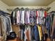 Walk-in closet with organized hanging clothes, providing ample storage space at 3541 Stoneleigh Walk, Lithonia, GA 30038