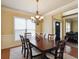 Traditional dining room with chandelier and dining table with seating for six at 3541 Stoneleigh Walk, Lithonia, GA 30038