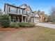Charming two-story home with brick accents, a two-car garage, and a covered porch at 3541 Stoneleigh Walk, Lithonia, GA 30038