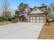 Charming two-story home with brick accents, a two-car garage, and a long driveway at 3541 Stoneleigh Walk, Lithonia, GA 30038