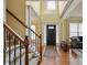 Inviting foyer with hardwood floors, a staircase, and a view of the front door at 3541 Stoneleigh Walk, Lithonia, GA 30038