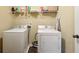 Convenient laundry area features washer, dryer and shelving at 3541 Stoneleigh Walk, Lithonia, GA 30038