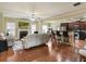 Open concept living area with hardwood floors and a fireplace at 3541 Stoneleigh Walk, Lithonia, GA 30038