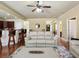 Open concept living area with cream-colored sofa, hardwood floors, and ceiling fan at 3541 Stoneleigh Walk, Lithonia, GA 30038