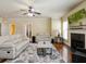 Comfortable living room featuring a fireplace and a plush white sofa at 3541 Stoneleigh Walk, Lithonia, GA 30038