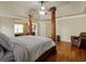 Main bedroom showcasing hardwood floors, and a four-poster bed with sitting area for relaxing space at 3541 Stoneleigh Walk, Lithonia, GA 30038
