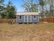 Backyard features a garden shed with a metal roof, offering great additional storage space at 3541 Stoneleigh Walk, Lithonia, GA 30038