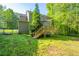 Spacious backyard featuring a wooden deck with stairs, ideal for outdoor entertaining and relaxation at 3988 Centennial Trl, Duluth, GA 30096