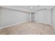 Finished basement room with tiled floors, white walls, and a closet with bi-fold doors at 3988 Centennial Trl, Duluth, GA 30096