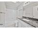 Cozy bathroom with combined shower and tub with granite counters at 3988 Centennial Trl, Duluth, GA 30096