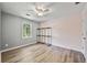 Bright bedroom with hardwood floors and shelving at 3988 Centennial Trl, Duluth, GA 30096