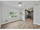Cozy dining room adjacent to kitchen, hardwood floors, and a large window at 3988 Centennial Trl, Duluth, GA 30096