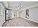 Basement with vinyl flooring, gray walls, refrigerator, and access to a kitchenette and staircase at 3988 Centennial Trl, Duluth, GA 30096