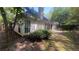 Rear exterior view with large windows and doors, patio, and privacy fence at 209 Southerness Ct, Stockbridge, GA 30281