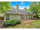 The back of the house shows a stone patio, glass doors and big windows to provide natural light at 209 Southerness Ct, Stockbridge, GA 30281