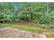 Stone patio overlooks a densely wooded backyard, offering a private and tranquil outdoor space at 209 Southerness Ct, Stockbridge, GA 30281