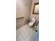 Accessible bathroom featuring safety grab bars and white tiling for convenience and cleanliness at 209 Southerness Ct, Stockbridge, GA 30281