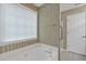 Bright bathroom features a large tub with a window at 209 Southerness Ct, Stockbridge, GA 30281