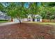 Charming single-story home features a two-car garage, manicured lawn, and inviting entrance with a blue door and blue shutters at 209 Southerness Ct, Stockbridge, GA 30281