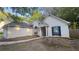 Single-story home with a well-manicured lawn, blue shutters, and attached garage at 209 Southerness Ct, Stockbridge, GA 30281