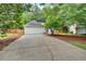 Charming single-story home features a two-car garage, manicured lawn, and inviting entrance with a blue door and blue shutters at 209 Southerness Ct, Stockbridge, GA 30281