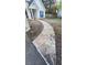 Stone walkway leads to the front door, complemented by blue shutters and a manicured lawn at 209 Southerness Ct, Stockbridge, GA 30281