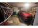 Spacious garage with vehicle, storage racks, and wall-mounted clothing rack at 209 Southerness Ct, Stockbridge, GA 30281