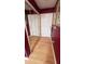 Hallway featuring hardwood floors and mirror creates an inviting and stylish passage within the home at 209 Southerness Ct, Stockbridge, GA 30281