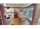 Well-lit kitchen with wooden floors, white cabinets, and a breakfast table at 209 Southerness Ct, Stockbridge, GA 30281