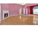 Spacious living room with hardwood floors, a fireplace, and open access to other rooms at 209 Southerness Ct, Stockbridge, GA 30281