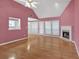 Open concept living room featuring hardwood floors, fireplace, and access to outdoor patio at 209 Southerness Ct, Stockbridge, GA 30281