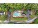 Aerial view of the community pool, surrounded by trees, lounge chairs, and well-maintained landscaping at 209 Southerness Ct, Stockbridge, GA 30281