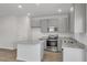 Modern kitchen with granite countertops, gray cabinets, and stainless steel appliances at 209 Weldon, Mcdonough, GA 30253