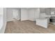 Open-concept living room and kitchen space with wood-style floors and ample natural light at 209 Weldon, Mcdonough, GA 30253