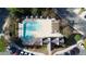 Overhead view of neighborhood pool with a surrounding deck, umbrellas, and landscaping at 2162 Spikerush Way, Buford, GA 30519