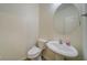 Half-bathroom with a pedestal sink, neutral walls, and wood-look flooring at 2162 Spikerush Way, Buford, GA 30519