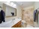 Neutral bathroom with warm tone tile shower, square sink mirror, and decorative lights at 2162 Spikerush Way, Buford, GA 30519