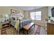 Comfortable bedroom featuring neutral walls, stylish furniture, and a sunny window at 2162 Spikerush Way, Buford, GA 30519