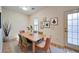 Cozy dining room with a table for six, neutral decor, and hardwood floors at 2162 Spikerush Way, Buford, GA 30519