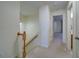Upstairs hallway with neutral walls, carpeted floors, and access to bedrooms at 2162 Spikerush Way, Buford, GA 30519